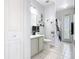 Bathroom features a gray vanity, tiled floor, and a shower with glass doors at 4109 Vessel Ct, Kissimmee, FL 34746