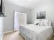Comfortable bedroom with light-colored walls, a large window, and a decorative artwork on the wall at 4109 Vessel Ct, Kissimmee, FL 34746