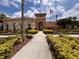 Stunning clubhouse exterior with manicured landscaping and an inviting entrance, decorated with American Flags at 4109 Vessel Ct, Kissimmee, FL 34746