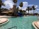 Large community pool with palm trees and lounge chairs provides a luxurious resort-style experience for residents at 4109 Vessel Ct, Kissimmee, FL 34746