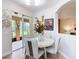 A cozy dining area with a round table, four chairs, and a view of the outdoor patio at 4109 Vessel Ct, Kissimmee, FL 34746
