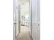 Hallway leading to the bathroom with multiple storage closets with white doors and gold knobs at 4109 Vessel Ct, Kissimmee, FL 34746