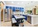 Modern kitchen with sleek stainless steel appliances, blue cabinets and a center island at 4109 Vessel Ct, Kissimmee, FL 34746