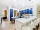 Bright kitchen showcasing blue cabinets, a pantry door, white countertops, and an island with seating at 4109 Vessel Ct, Kissimmee, FL 34746