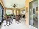 Covered lanai with a tile floor features multiple rocking chairs and an overhead ceiling fan at 4109 Vessel Ct, Kissimmee, FL 34746