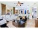 Open concept living room flows into a modern kitchen with white countertops and a dining area at 4109 Vessel Ct, Kissimmee, FL 34746