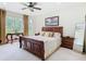 Inviting main bedroom with a large bed, decorative accents, and a window offering a peaceful view at 4109 Vessel Ct, Kissimmee, FL 34746