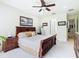 Comfortable main bedroom showcasing a king bed, a ceiling fan, and a serene ambiance at 4109 Vessel Ct, Kissimmee, FL 34746
