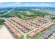 Real estate aerial view of a sprawling residential neighborhood, meticulously planned with rows of homes and manicured greenery at 423 Paloma Dr, Davenport, FL 33837