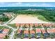 Gorgeous aerial view of a residential community with beautiful homes, orange tile roofs, and lush green landscaping at 423 Paloma Dr, Davenport, FL 33837