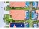 Aerial view of neighborhood homes with pools, tile roofs, manicured lawns, and proximity to street and green spaces at 423 Paloma Dr, Davenport, FL 33837