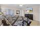 A bedroom shows a TV mounted on the wall, a dresser, and a bed with patterned bedding at 423 Paloma Dr, Davenport, FL 33837