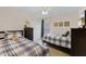 Bedroom featuring two beds, dresser, closet, neutral walls, and ceiling fan at 423 Paloma Dr, Davenport, FL 33837