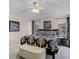 A bedroom features a bed with black-and-white bedding, a ceiling fan, neutral walls, and bedside tables with lamps at 423 Paloma Dr, Davenport, FL 33837