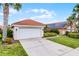 Charming single-story home with a well-maintained lawn and two car garage at 423 Paloma Dr, Davenport, FL 33837