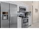 Stylish kitchen equipped with stainless steel appliances, white cabinets, and modern countertops at 423 Paloma Dr, Davenport, FL 33837