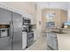 Modern kitchen featuring stainless steel appliances, white cabinetry, and a bright eat-in area at 423 Paloma Dr, Davenport, FL 33837