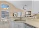 Bright kitchen with stainless steel sink and an open view into the living and dining areas at 423 Paloma Dr, Davenport, FL 33837