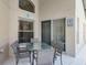 A patio features an outdoor dining set with a glass table and gray chairs at 423 Paloma Dr, Davenport, FL 33837