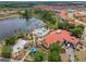 Aerial view of community pool with lake, playground, and clubhouse at 423 Paloma Dr, Davenport, FL 33837