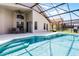 Stunning screened-in pool with a patio, table, and lounge chairs at 423 Paloma Dr, Davenport, FL 33837