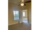 Bright bedroom featuring a ceiling fan, neutral carpeting and a large window at 429 Fountainhead Cir # 223, Kissimmee, FL 34741