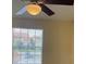 Bedroom features a ceiling fan, window with neighborhood view and neutral walls at 429 Fountainhead Cir # 223, Kissimmee, FL 34741