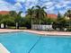Community pool offering a refreshing escape with lounge chairs for relaxation amidst lush greenery at 429 Fountainhead Cir # 223, Kissimmee, FL 34741