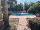 View of a community pool surrounded by greenery at 429 Fountainhead Cir # 223, Kissimmee, FL 34741