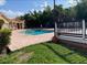 Community pool with brick surround, lush landscaping, and a nearby clubhouse offering relaxation at 429 Fountainhead Cir # 223, Kissimmee, FL 34741