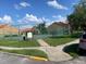 Tennis court with well-maintained surface, surrounded by lush greenery and offering an active lifestyle at 429 Fountainhead Cir # 223, Kissimmee, FL 34741