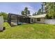 Spacious backyard featuring a screened-in pool, storage shed, lush green grass, and a privacy fence at 4307 Oak Ct, St Cloud, FL 34769