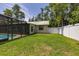 Lush backyard view, featuring a screened-in pool, shed, manicured lawn, and a crisp privacy fence at 4307 Oak Ct, St Cloud, FL 34769
