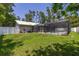 Expansive backyard view, complete with a pool, lush green lawn, and secured by a white privacy fence at 4307 Oak Ct, St Cloud, FL 34769