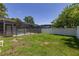 The spacious backyard features a screened pool enclosure and a white privacy fence at 4307 Oak Ct, St Cloud, FL 34769