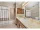 Bathroom with shower-tub combination, vanity and decorative wallpaper at 4307 Oak Ct, St Cloud, FL 34769