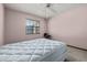 This bedroom features neutral walls, carpeted floors, a ceiling fan, and a window for natural light at 4307 Oak Ct, St Cloud, FL 34769