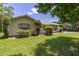 Charming home exterior showcasing lush landscaping, a well-manicured lawn, and natural light at 4307 Oak Ct, St Cloud, FL 34769