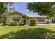 Charming home exterior showcasing lush landscaping, a well-manicured lawn, and natural light at 4307 Oak Ct, St Cloud, FL 34769