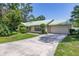 Charming home exterior with lush landscaping, a well-manicured lawn, and natural light at 4307 Oak Ct, St Cloud, FL 34769