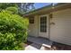 Front entrance with sidelight and a charming porch light and well maintained lawn at 4307 Oak Ct, St Cloud, FL 34769