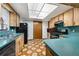 Charming kitchen with wood cabinets, a black gas range, and turquoise countertops at 4307 Oak Ct, St Cloud, FL 34769