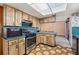 Cozy kitchen with wood cabinets and stove with range hood at 4307 Oak Ct, St Cloud, FL 34769