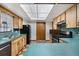 Cozy kitchen boasting wood cabinetry, black appliances, and ample counter space at 4307 Oak Ct, St Cloud, FL 34769