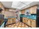 Kitchen with wood cabinets, a black dishwasher, and turquoise countertops at 4307 Oak Ct, St Cloud, FL 34769