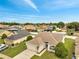Aerial shot of charming house, driveway, manicured lawns, and neighborhood at 440 Peppermill Cir, Kissimmee, FL 34758