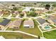 Aerial view of house with lush yard and view of community pond and surrounding neighborhood at 440 Peppermill Cir, Kissimmee, FL 34758