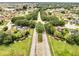 A beautiful aerial view of a residential community with tree lined streets at 440 Peppermill Cir, Kissimmee, FL 34758