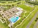 Community amenities including a pool, parking, open green space, a pond, and access to a golf course at 440 Peppermill Cir, Kissimmee, FL 34758
