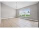 Dining area features tile floors, a modern chandelier, and a large bright window at 440 Peppermill Cir, Kissimmee, FL 34758